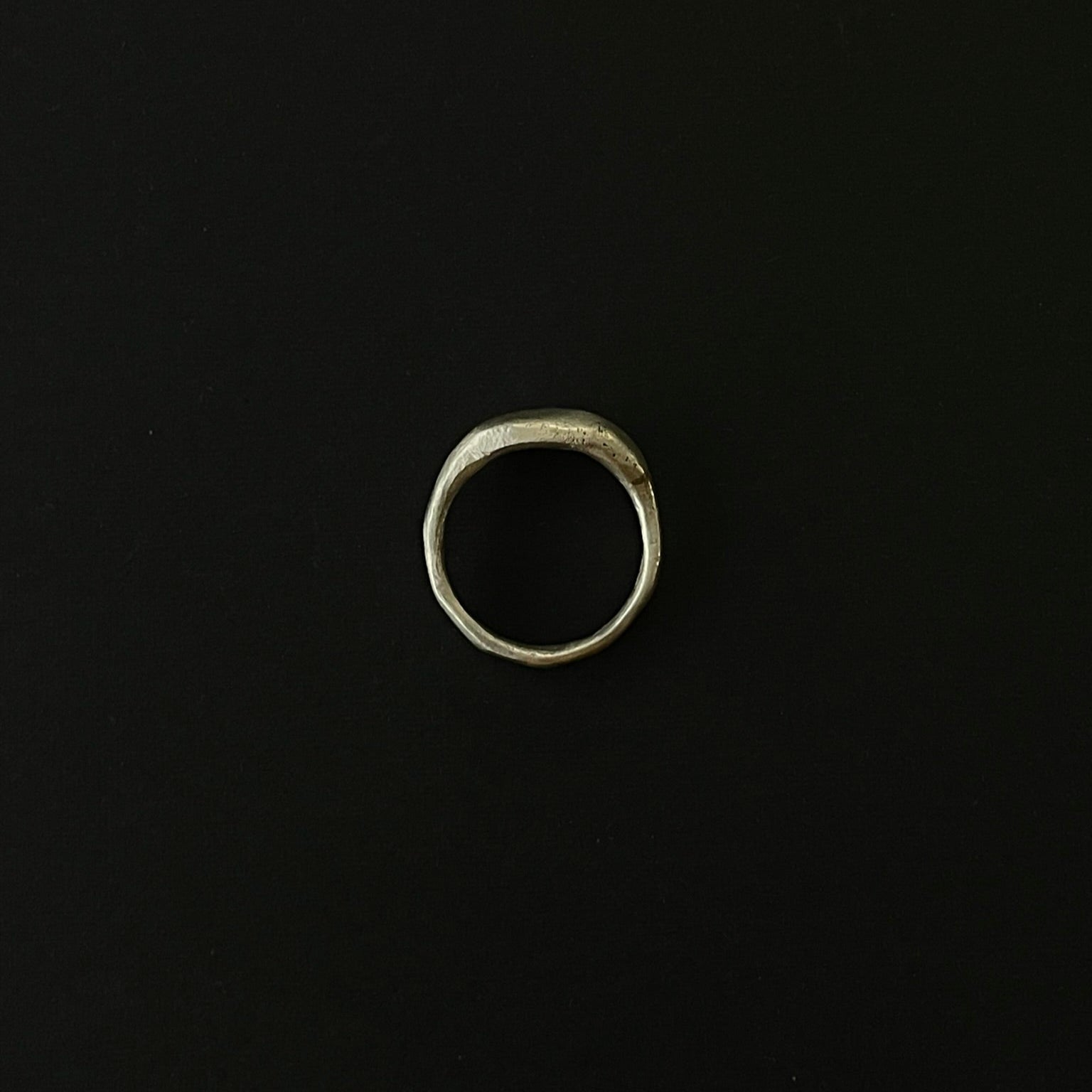 Silver ring on a black background